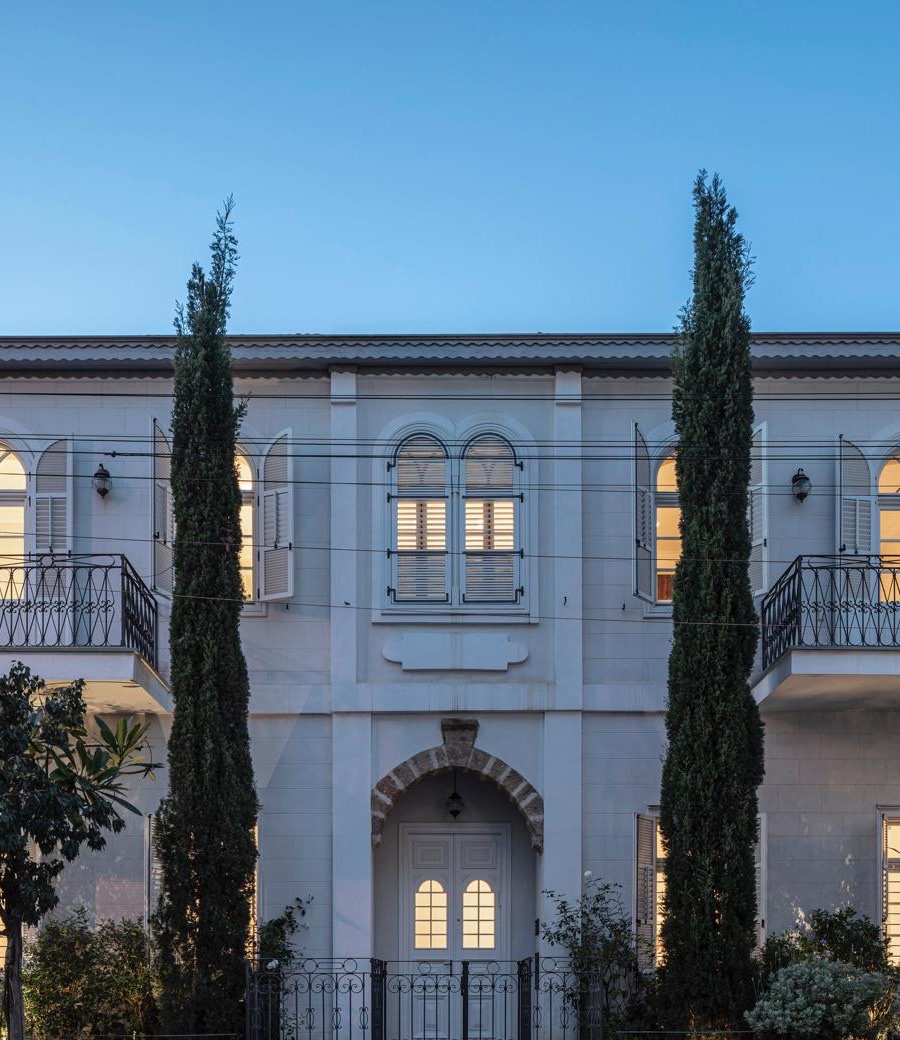 Illuminated facade of a luxury Tel Aviv residence at dusk, part of the Real Capital Premium portfolio