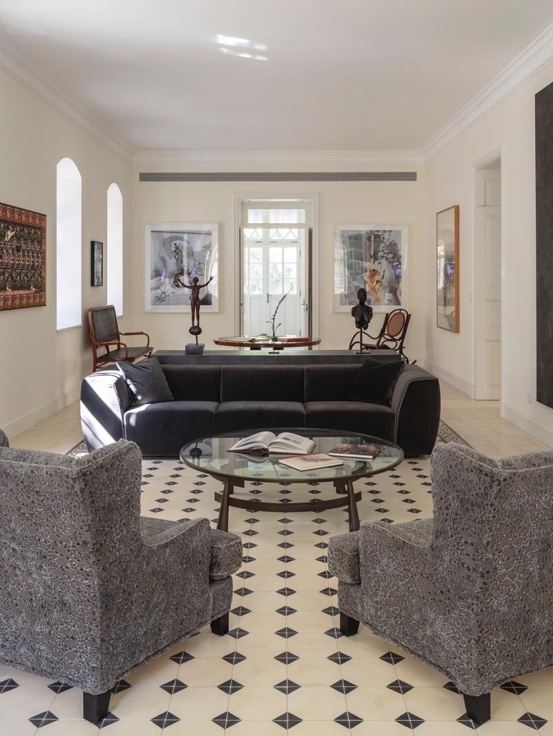 Salon of a restored Tel Aviv residence with patterned tile floor